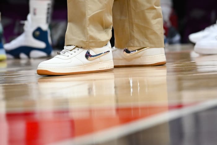View of white and metallic Nike shoes.